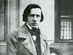Chopin zdjecie. Fryderyk Chopin, polski kompozytor, w eleganckim płaszczu i z charakterystyczną fryzurą.