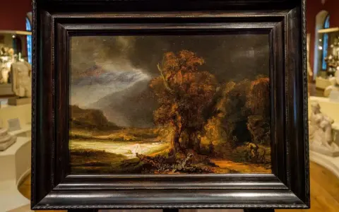 Krajobraz z burzą i rzeką, jeden z **rembrandt najpopularniejsze obrazy**. Mroczne niebo, drzewa i postacie w oddali.