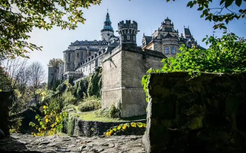 Majestatyczne zamki Czech na wzgórzu, otoczone zielenią i kamiennymi murami, wyglądają jak z bajki.