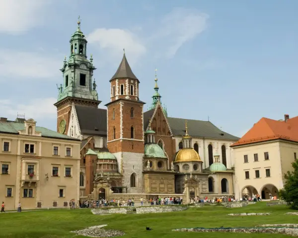 Wawel w średniowieczu – majestatyczna katedra i zamek, świadkowie historii Polski, otoczone zielonym dziedzińcem.
