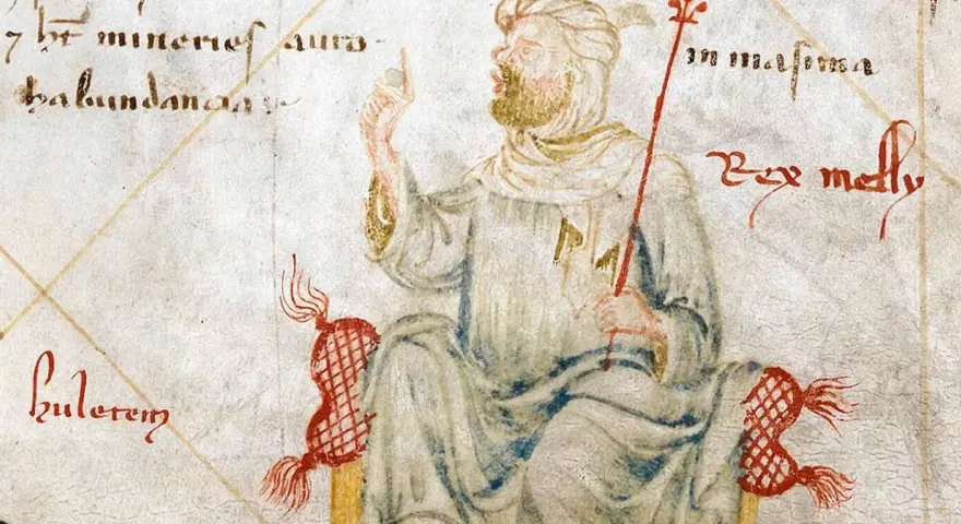 Ilustracja przedstawia Mansę Musę, władcę Mali, symbolizującego jego ogromny majątek. Król siedzi na tronie, trzymając berło.